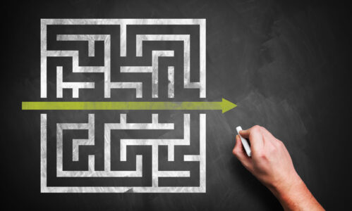 hand drawing a shortcut to a maze on a chalkboard hand drawing a shortcut to a maze on a chalkboard